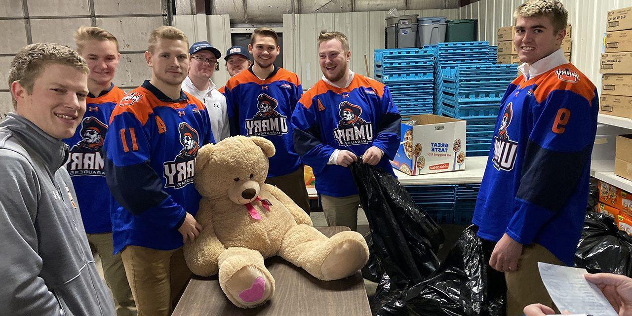 Marauders Hockey Team Volunteering with Teddy Bear Toss